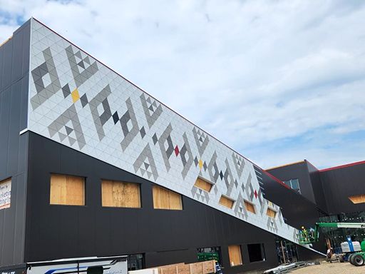 A large building with a lot of windows is being built.