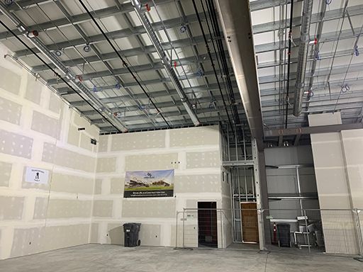 A large empty room with a ceiling that is being built.