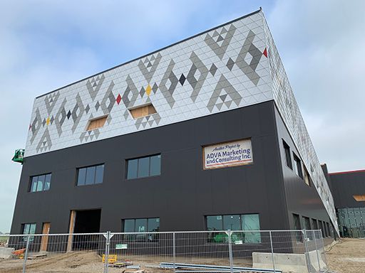 A large building under construction with a fence around it.