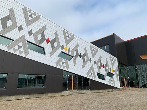 A large building with a geometric design on the side of it.