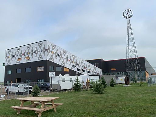 A large building with a picnic table in front of it