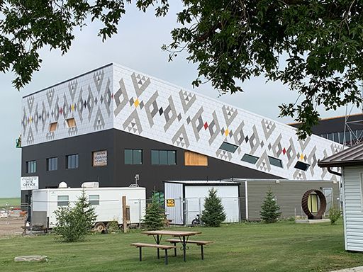 A large building with a picnic table in front of it