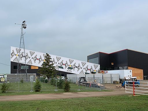 A large building with a windmill in front of it is being built.