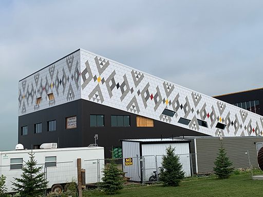 A large building with a native american design on the side of it.