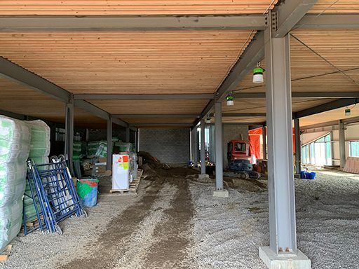 The inside of a building under construction with a wooden ceiling.