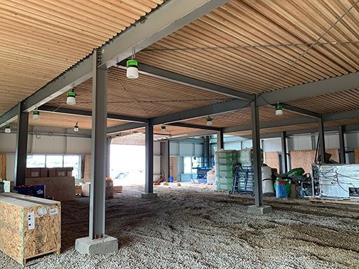 The inside of a building under construction with a wooden ceiling.