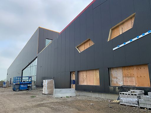 A large building with a lot of windows is being built.