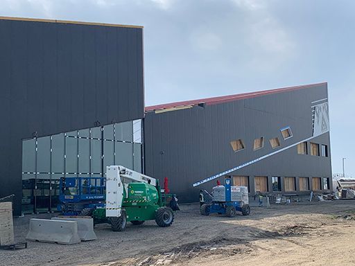 A large building with a lot of windows is being built.