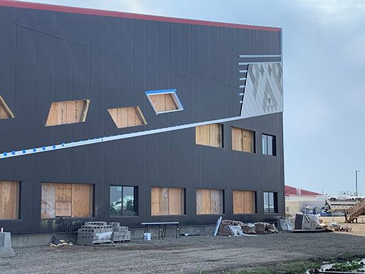 A large building with a lot of windows is being built.