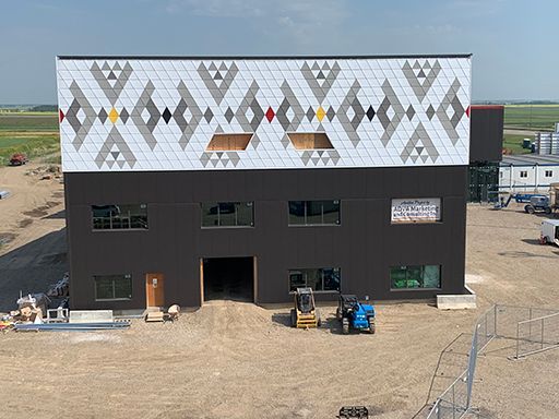 An aerial view of a building under construction with a native american design on the side.