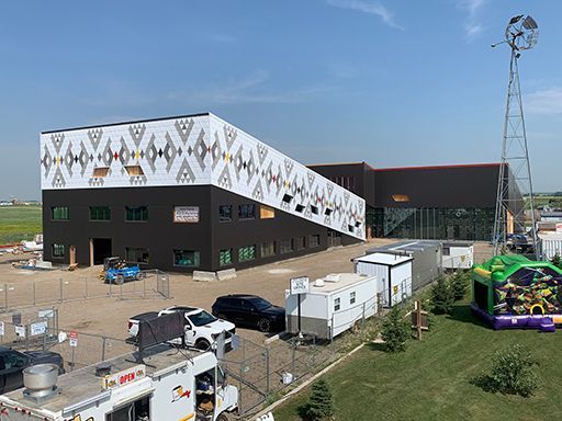 An aerial view of a large building with a bouncy house in front of it.