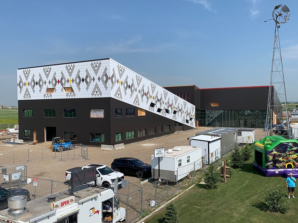 An aerial view of a large building with a bouncy house in front of it.