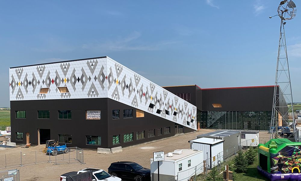 An aerial view of a large building with a bouncy house in front of it.