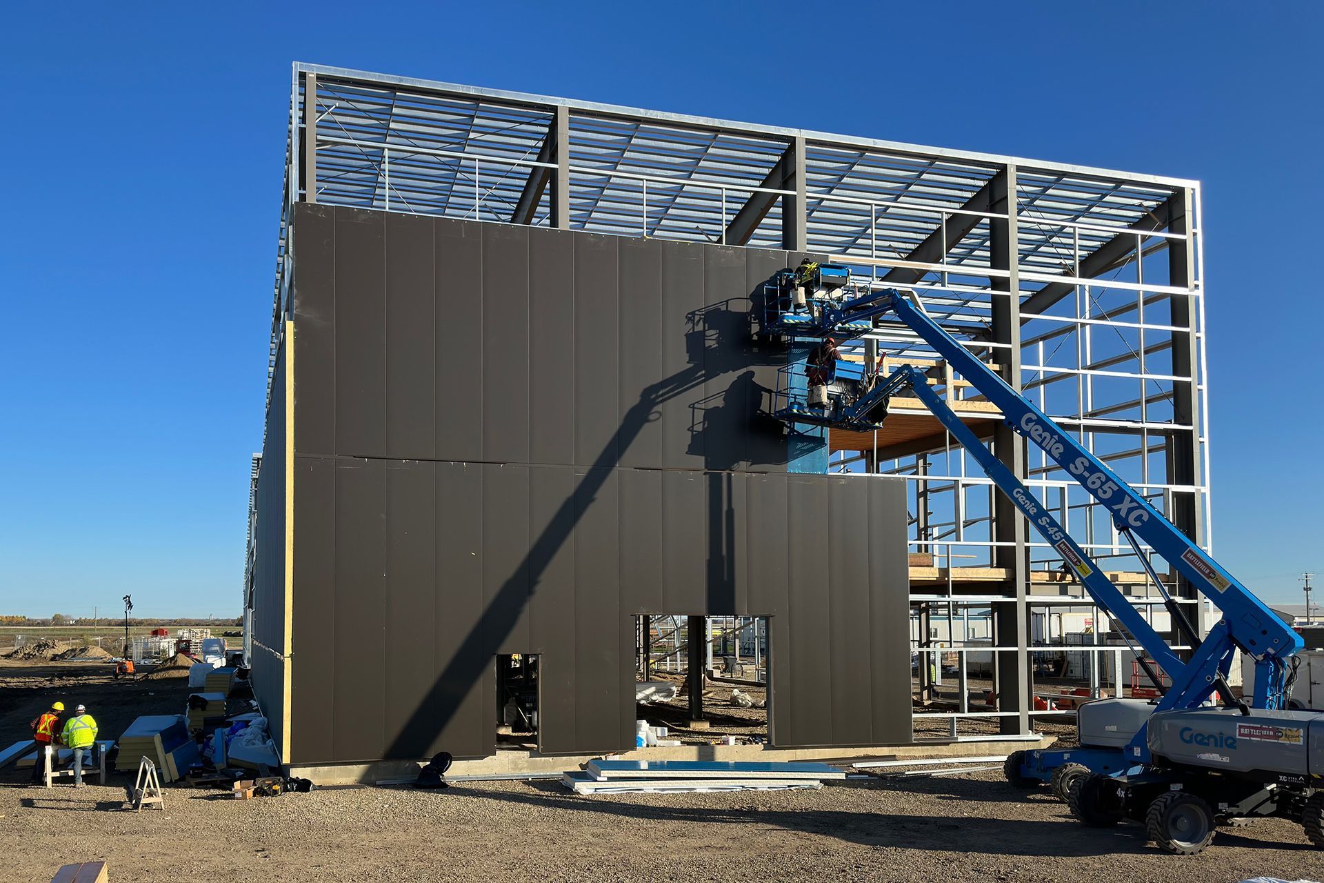 A large building is being built with a crane.