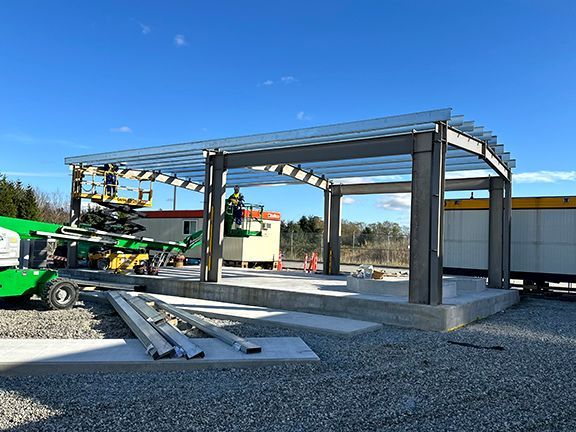 Small industrial building frame sits atop concrete pad at the airport in Vancouver.