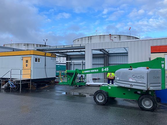 Metal panels are installed onto a storage building at Vancouver Airport by DBC.