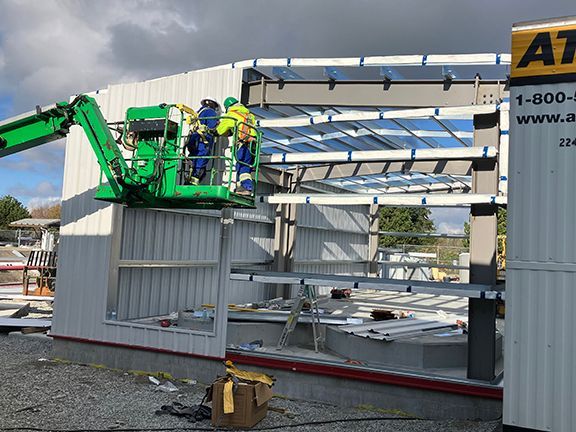 Roof trussing being added at Vancouver airport storage building project.