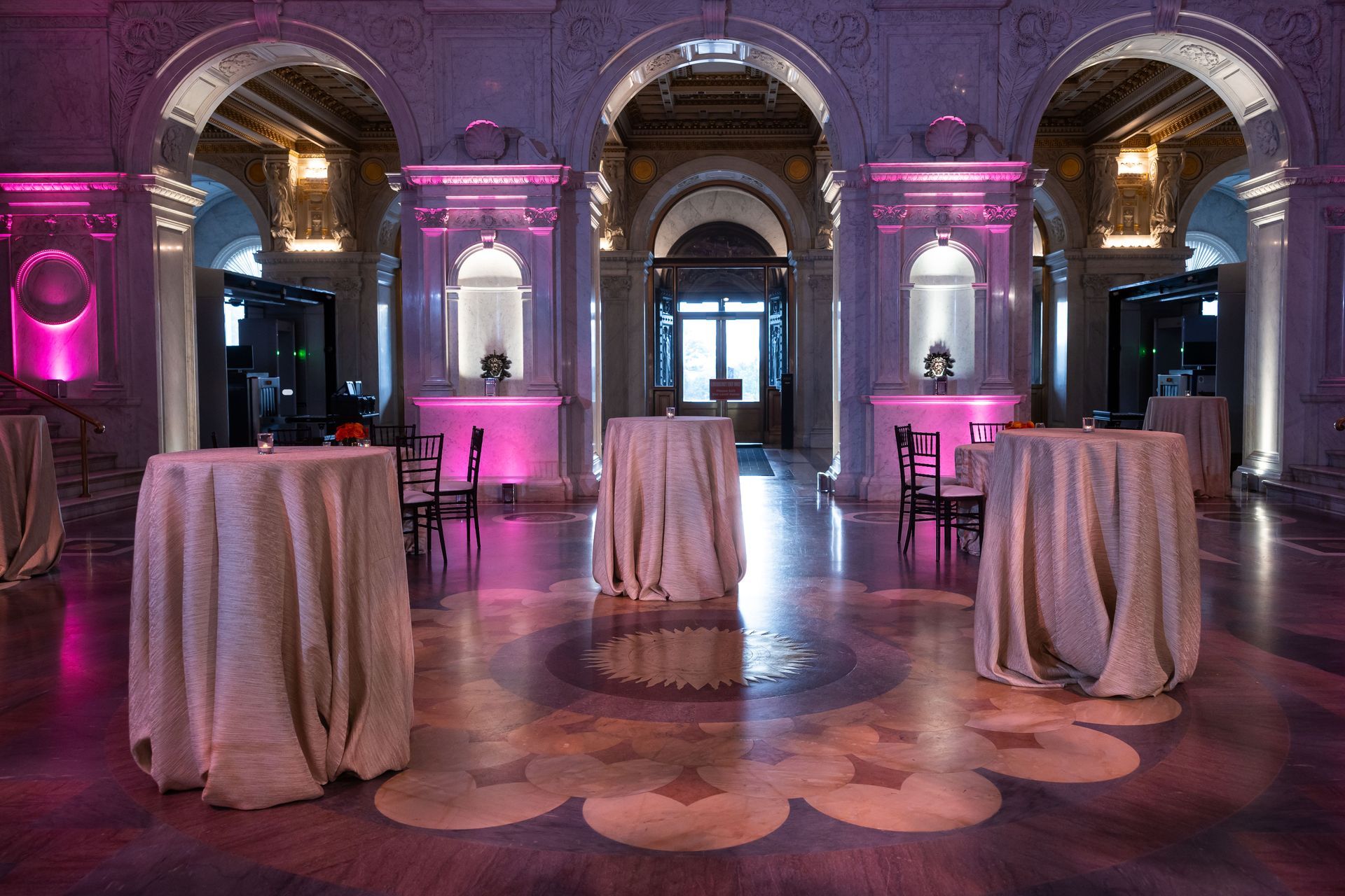 A large room with tables and chairs in it.