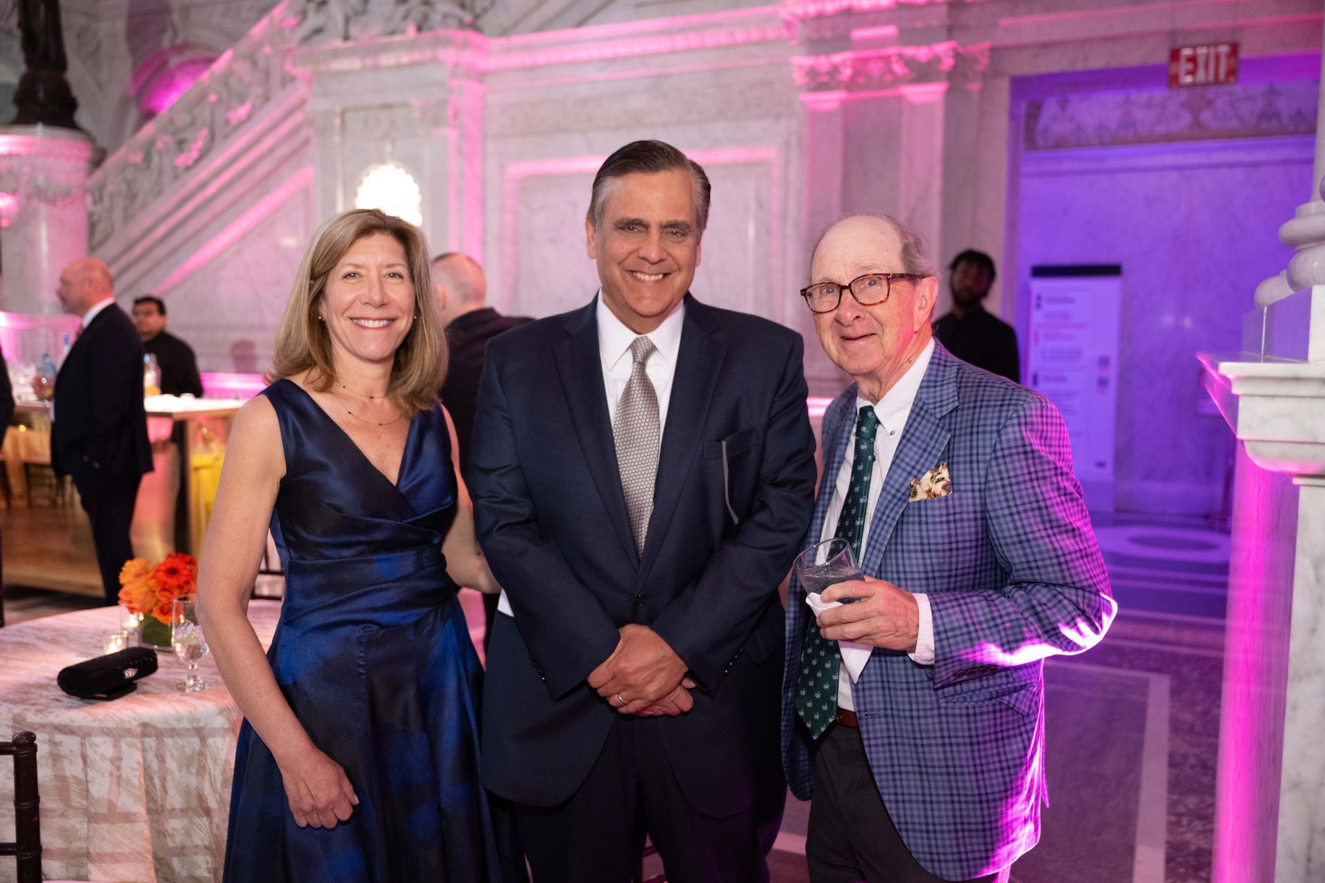 A group of people are posing for a picture in a room.