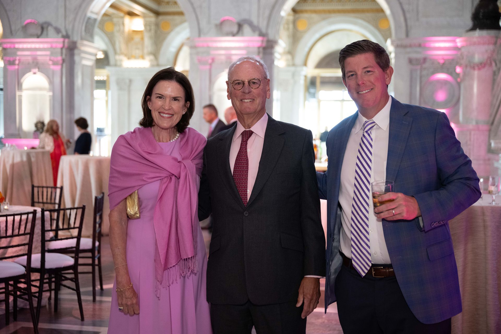 A group of people are posing for a picture in a room.