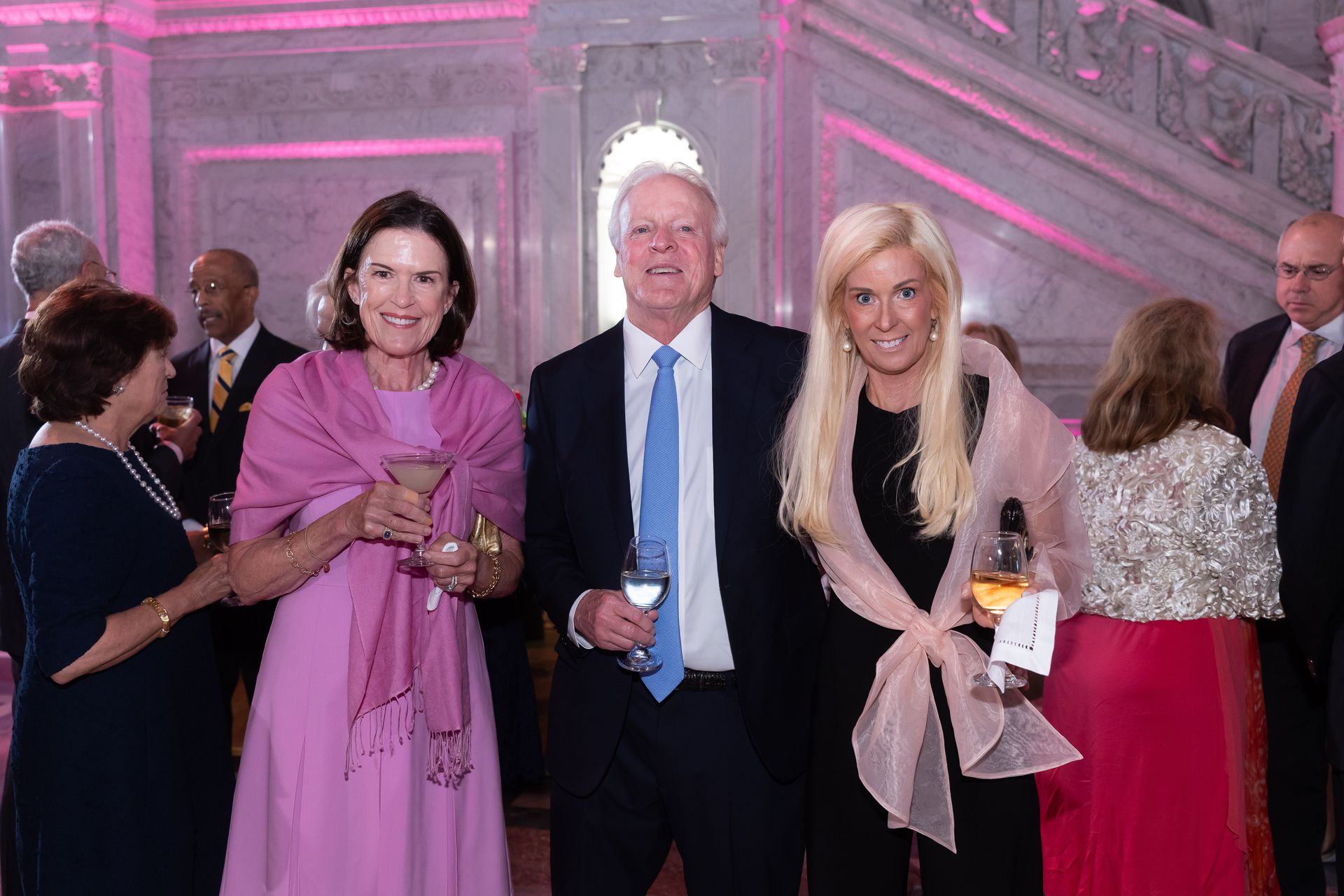 A group of people are posing for a picture at a party.