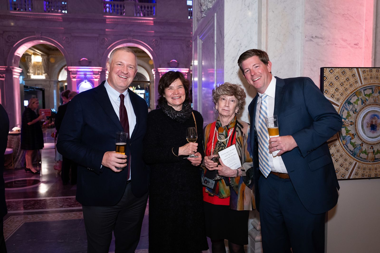A group of people in suits and ties are posing for a picture.