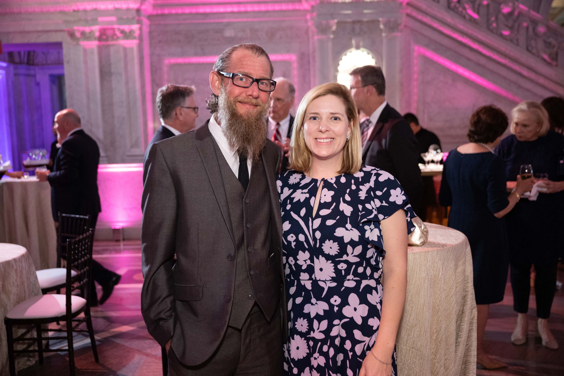 A man and a woman are posing for a picture at a party.
