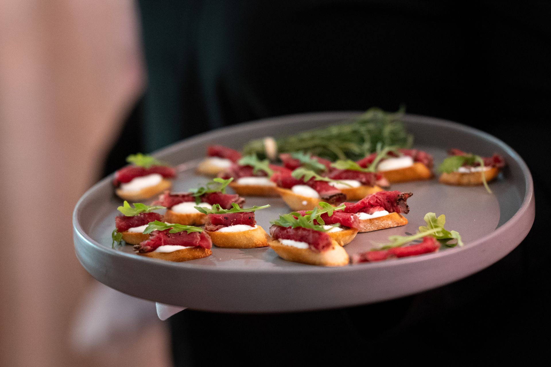 A person is holding a plate of food on a tray.
