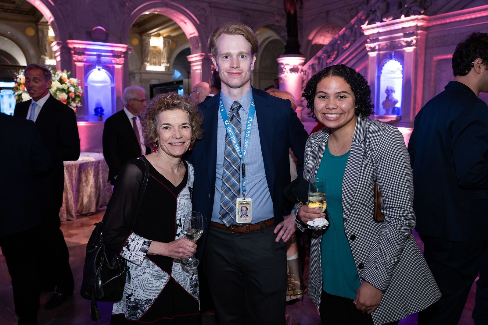 A group of people are posing for a picture in a room.
