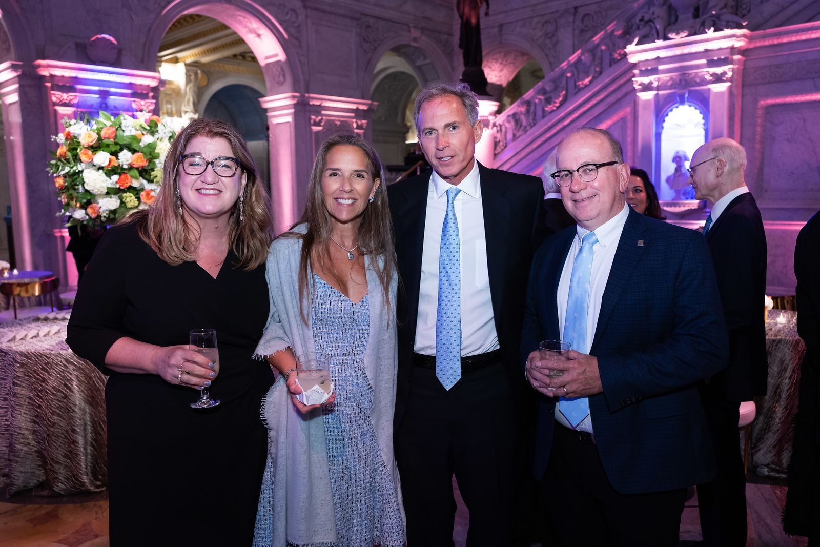 A group of people are posing for a picture at a party.