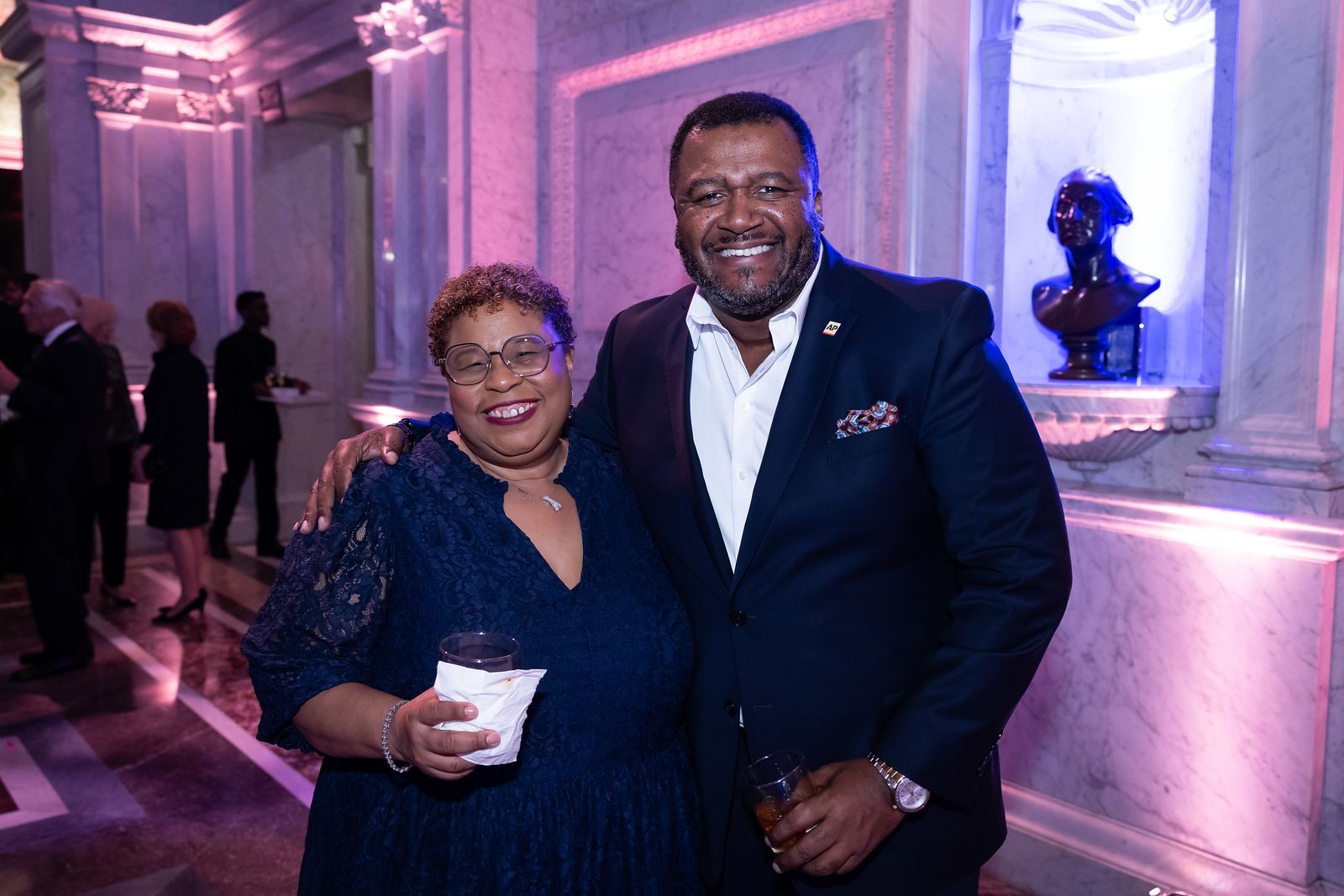 A man and a woman are posing for a picture in a room.