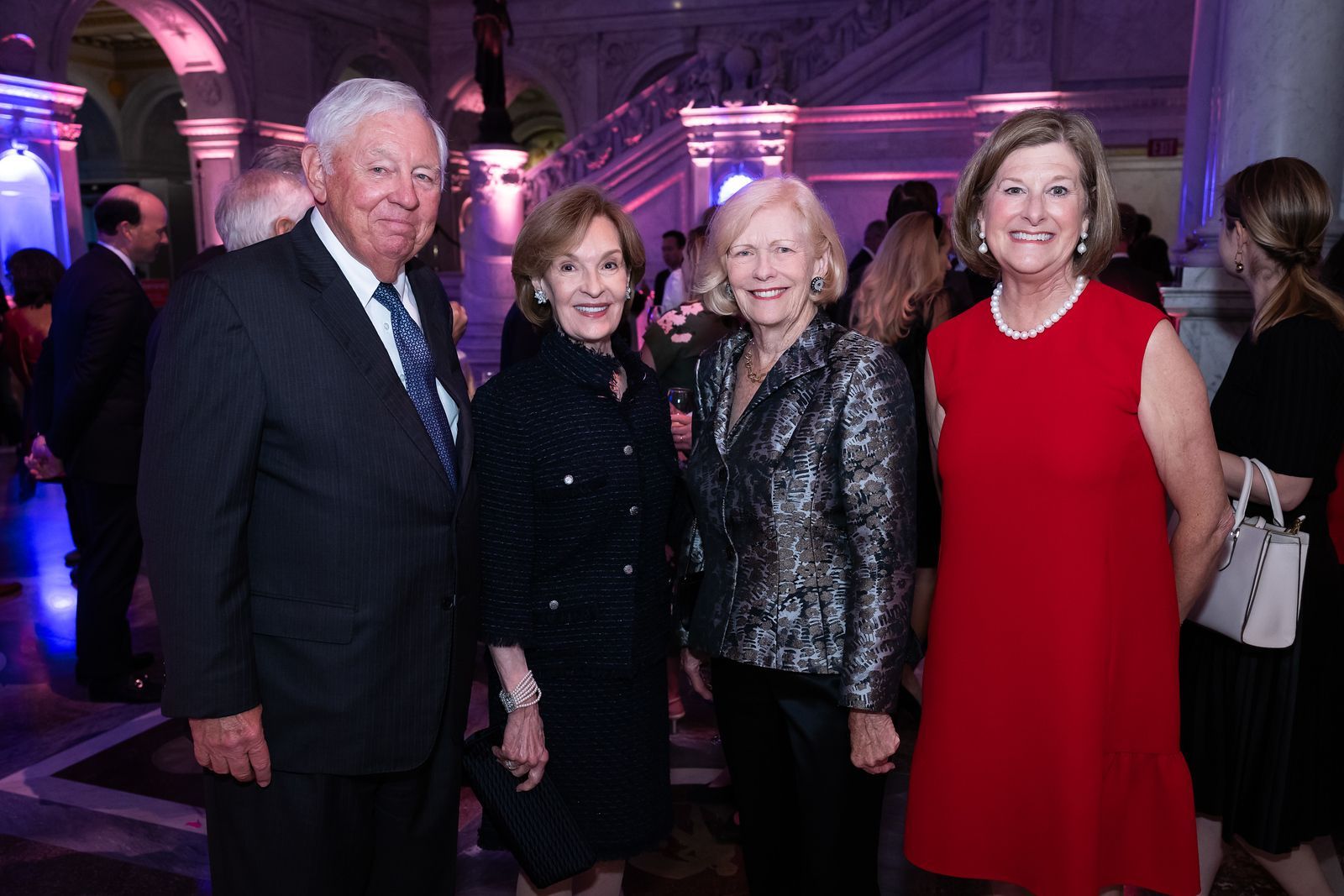 A group of people are posing for a picture at a party.
