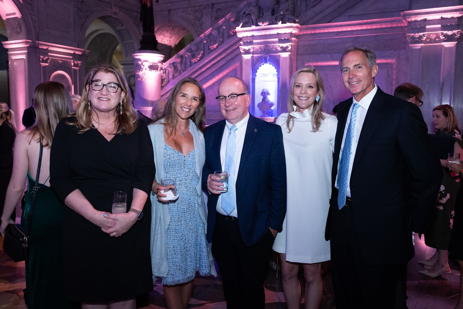 A group of people are posing for a picture at a party.