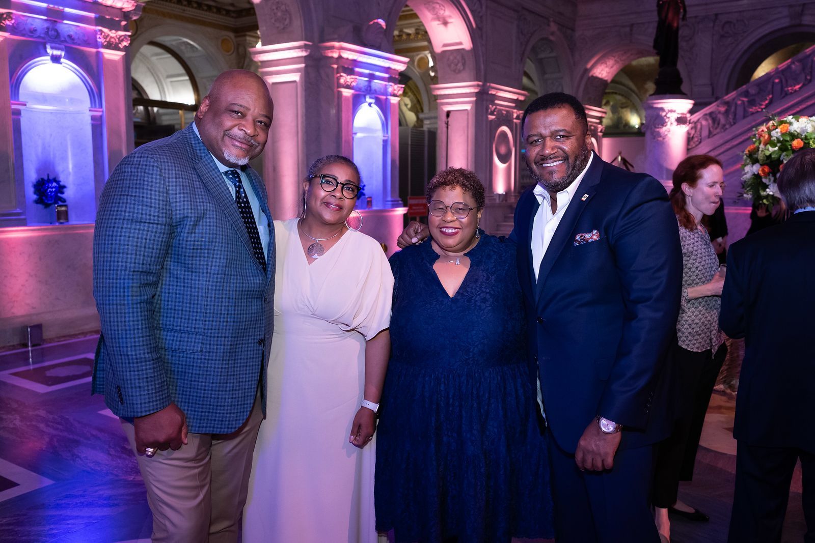 A group of people are posing for a picture at a party.