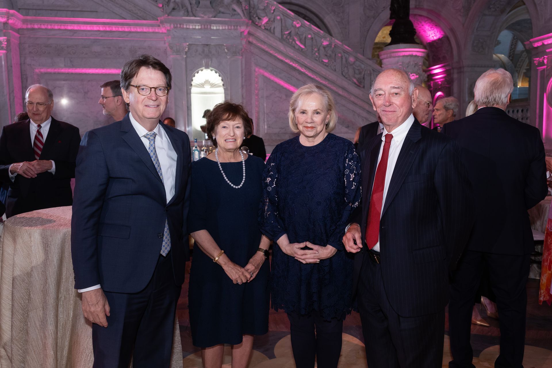 A group of people standing next to each other in a room.