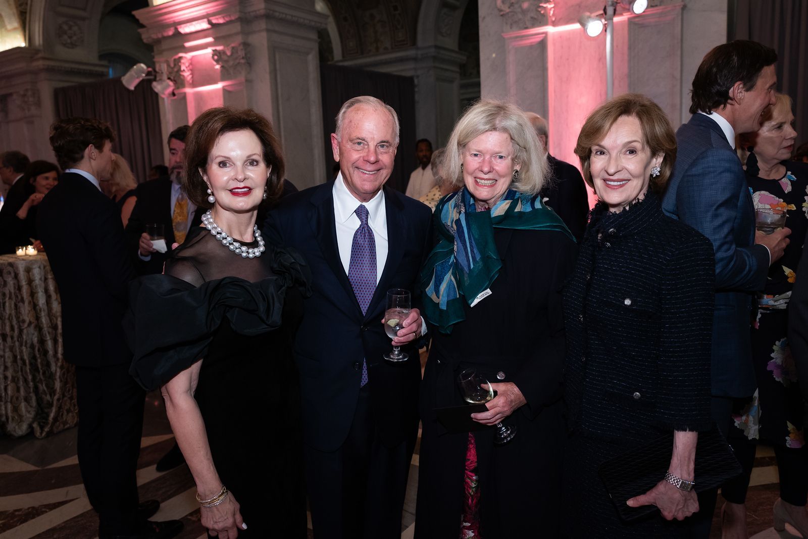A group of people are posing for a picture at a party.