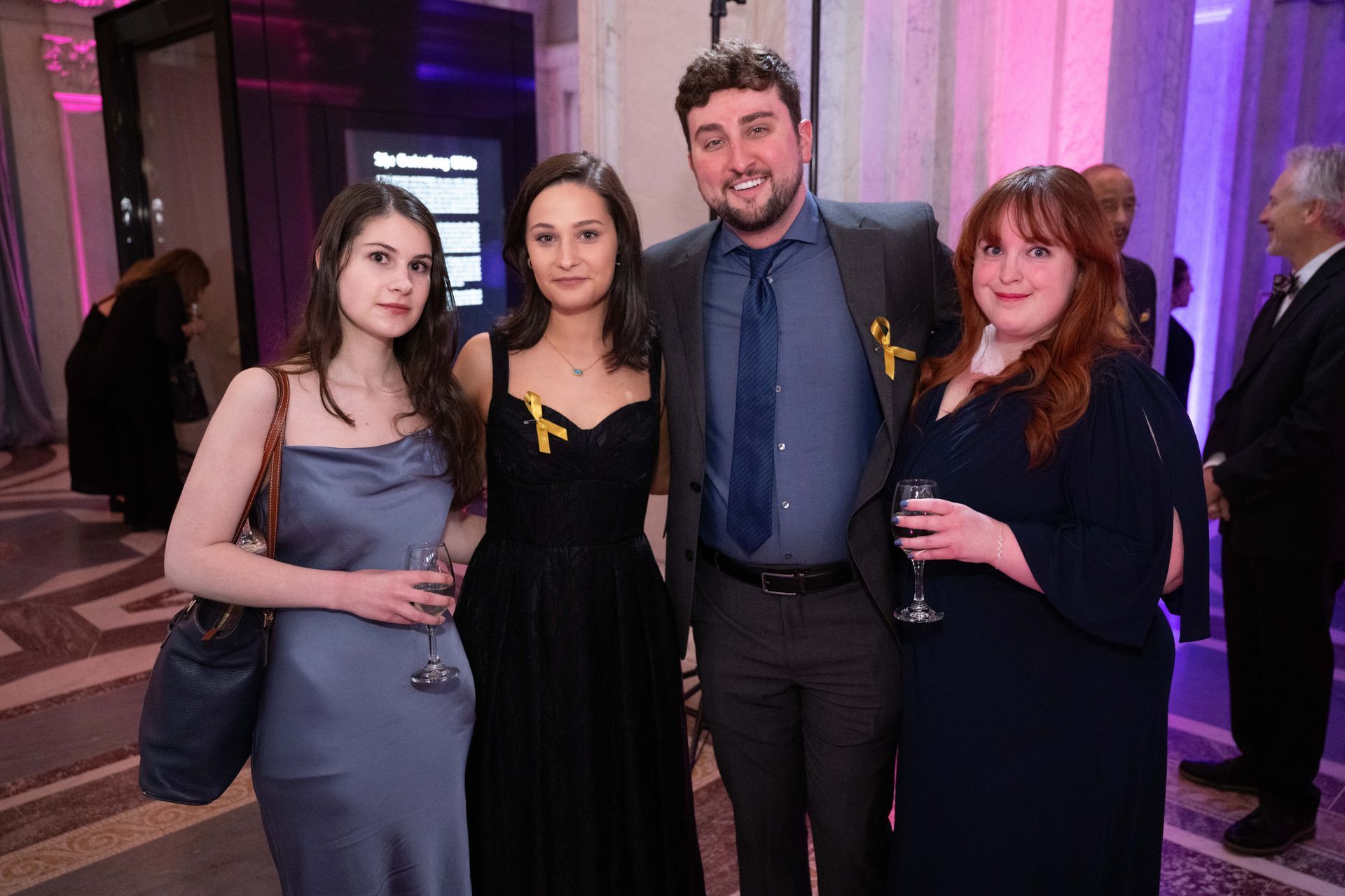 A group of people are posing for a picture at a party.
