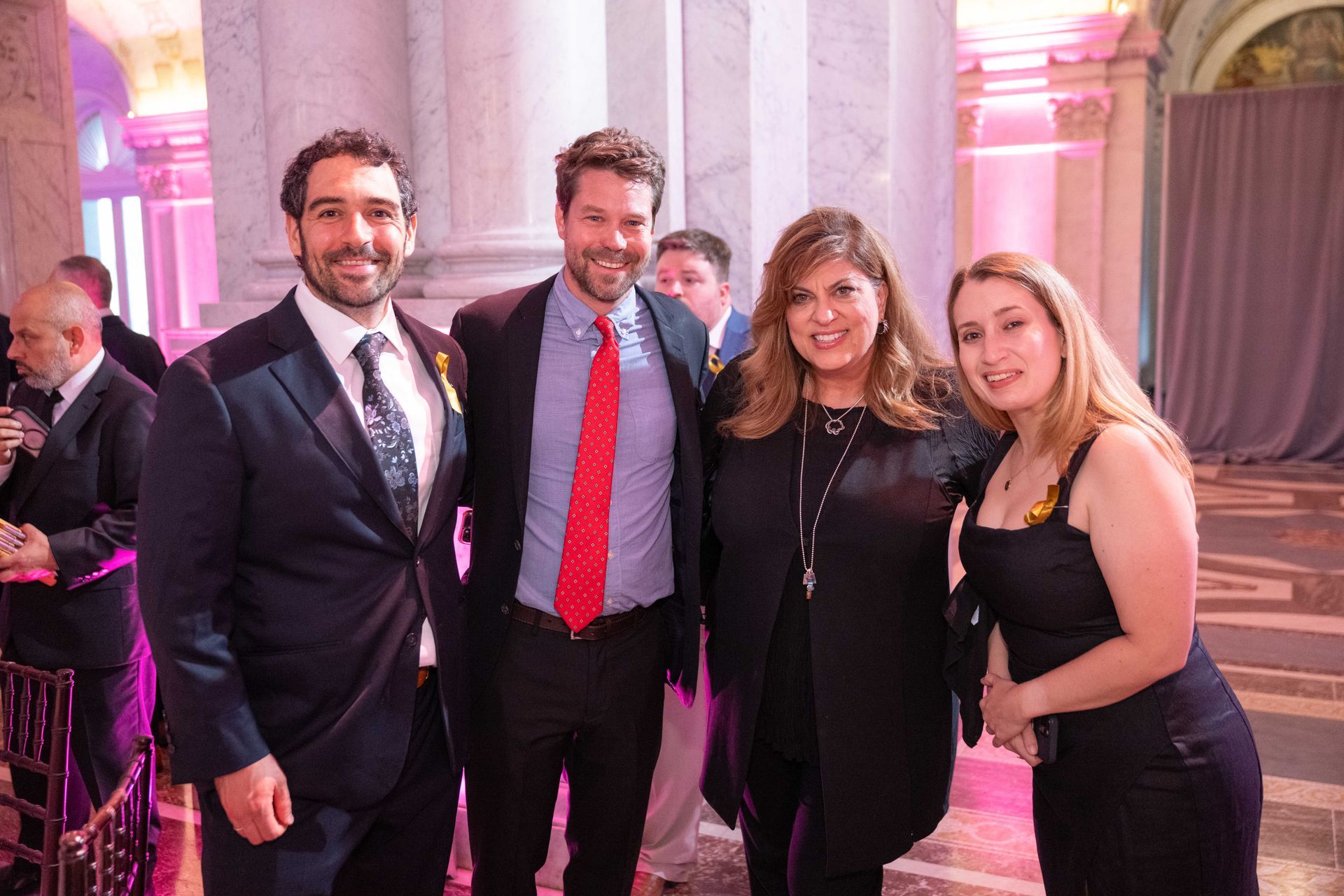 A group of people in suits and ties are posing for a picture.