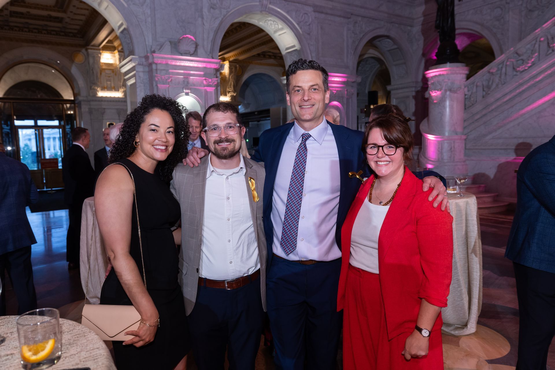 A group of people are posing for a picture at a party.