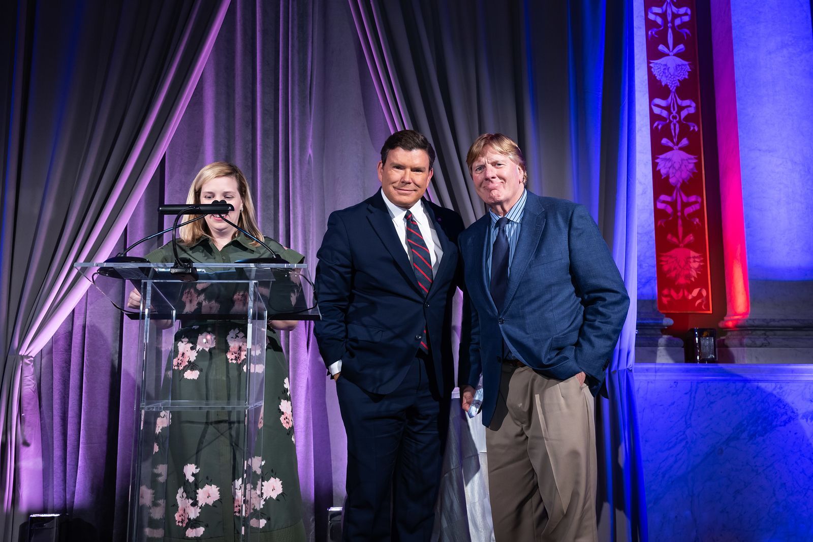 A group of people standing next to each other on a stage.