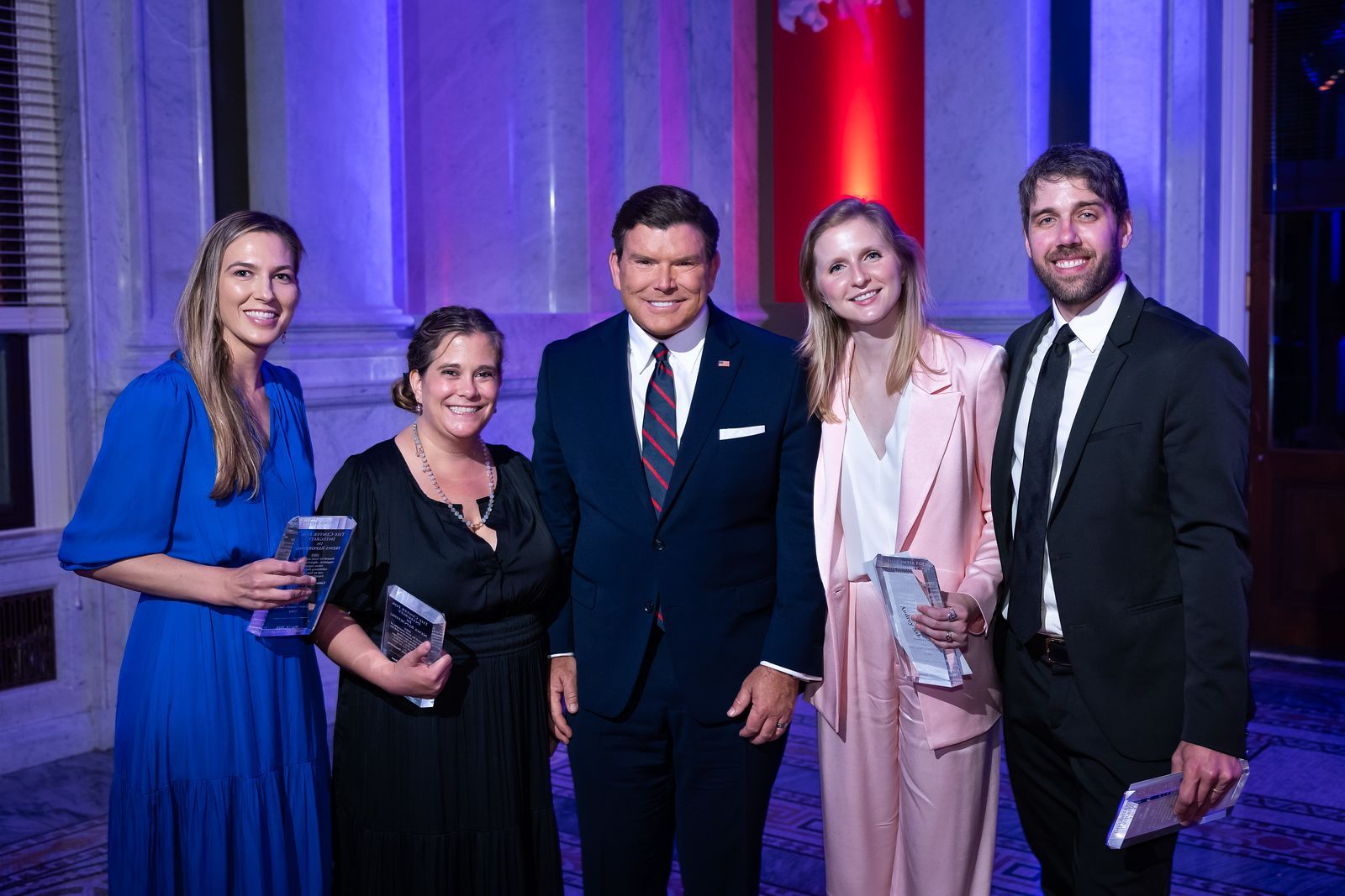 A group of people in suits and ties are posing for a picture.