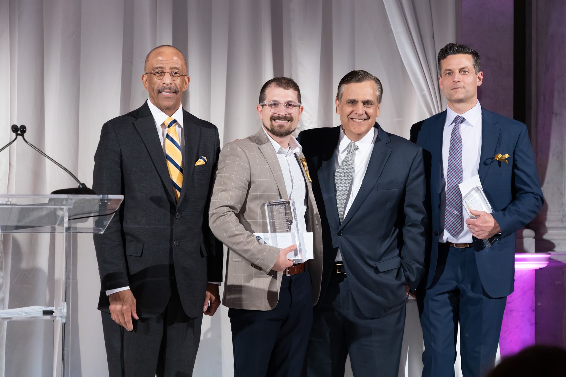 A group of men in suits and ties are posing for a picture.