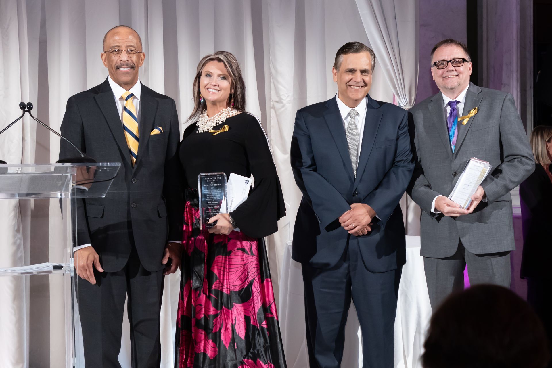 A group of people in suits and ties are posing for a picture.