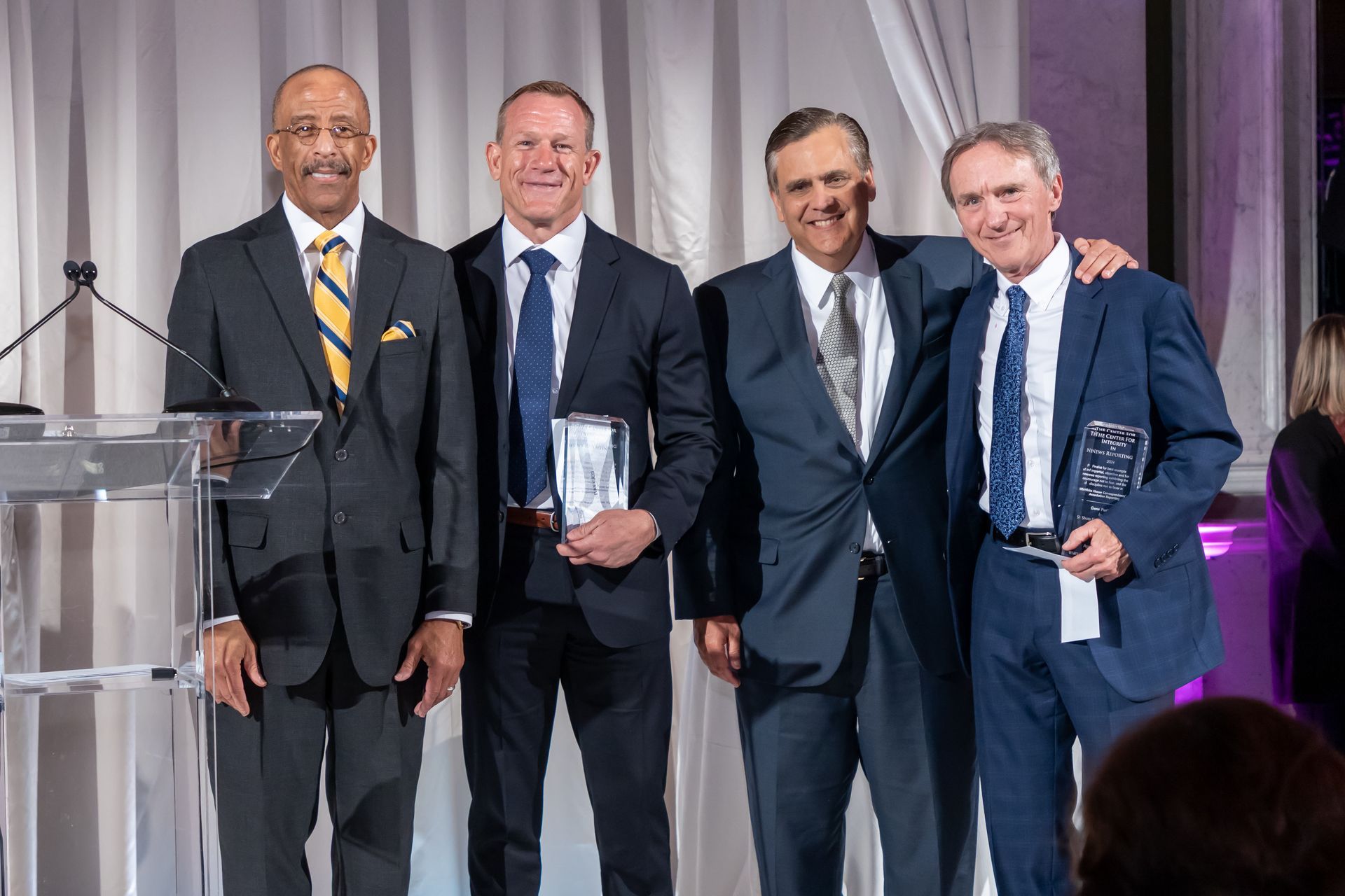 A group of men in suits and ties are posing for a picture.