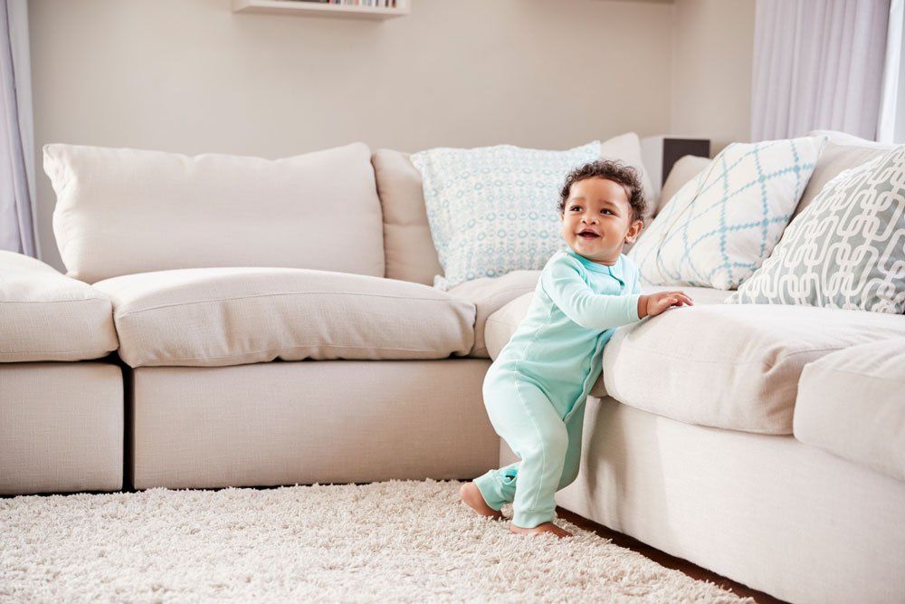 Happy Mixed Race Toddler Boy Playing In Sitting Room — North Hollywood, CA — So White Carpet Cleaning LLC