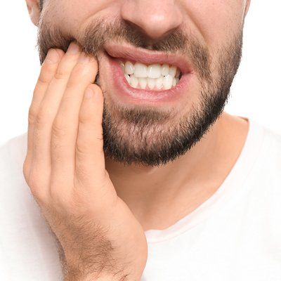Man with toothache needing emergency dental care