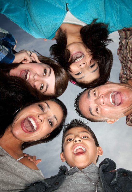 Husband, wife, and three children with great smiles
