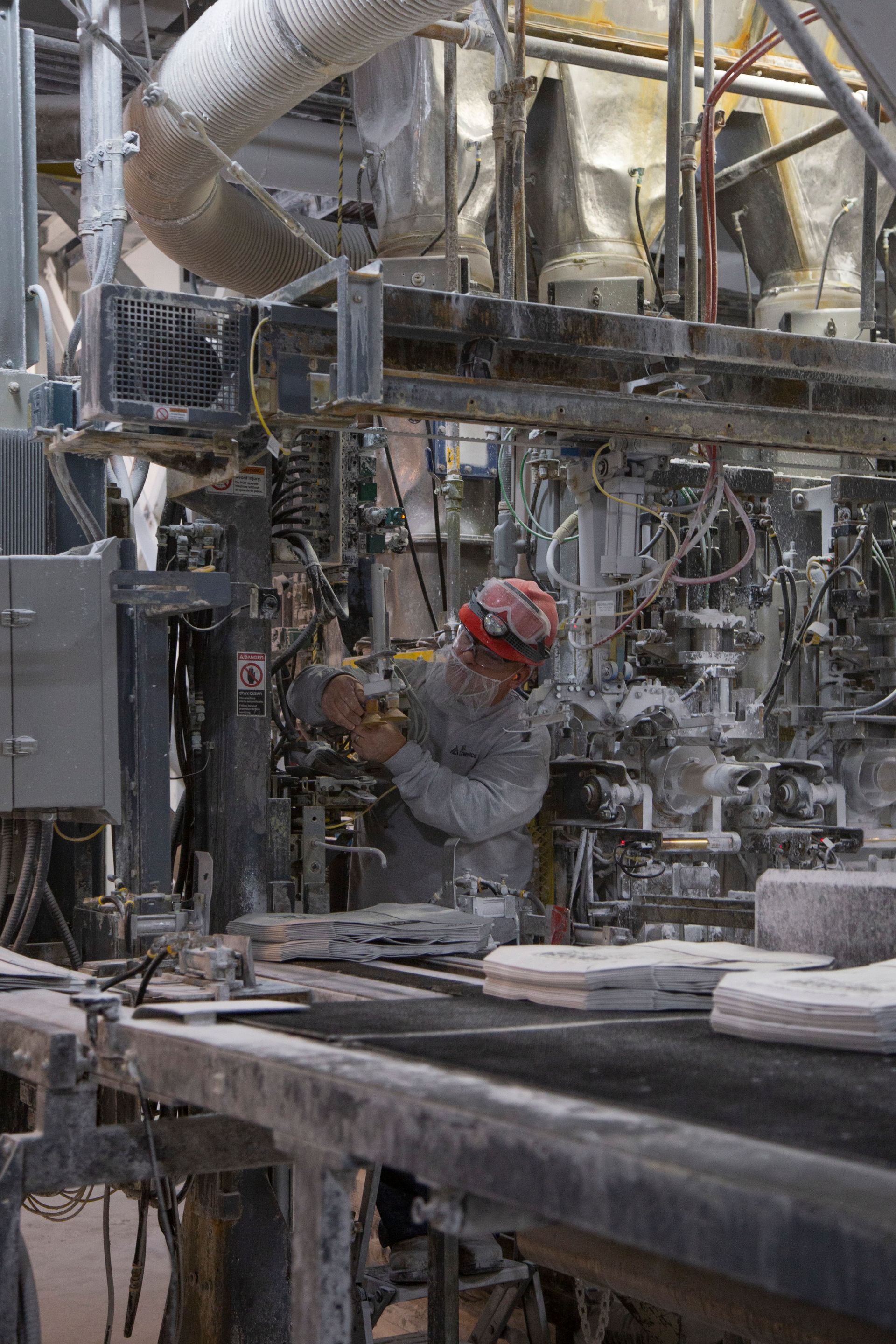 Professional photograph of a skilled laborer working with a large piece of machinery.
