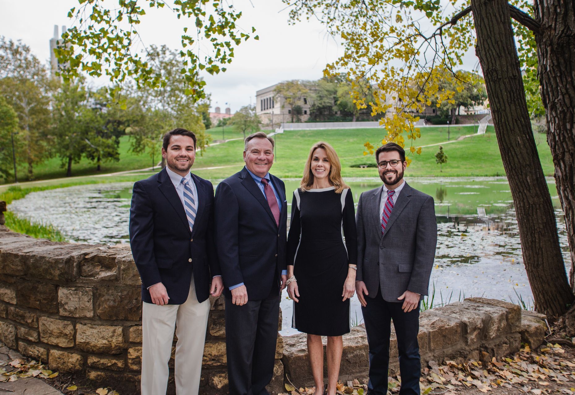 Professional photograph of people standing by a pond taken by KMG.
