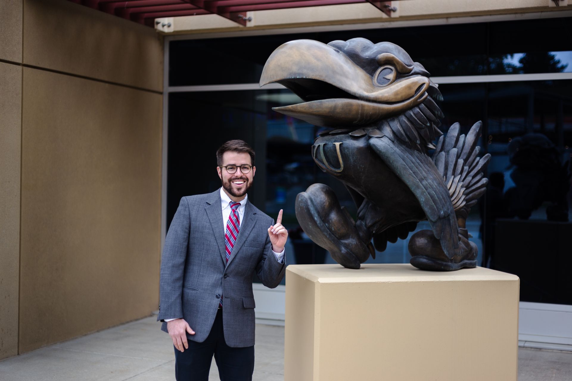 Professional photograph of a man standing by a Jayhawk taken by KMG.